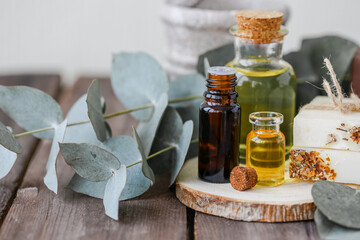 Assortment of natural oils in glass bottles on wooden background. Concept of pure organic ingredients in cosmetology. Bath accessories, atmosphere of harmony, relax. Close up macro. Healthy lifestyle