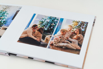 a book with new year photos of big family at home on a white background