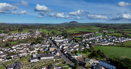 Fototapeta na wymiar Aerial photo of Broughshane village Residential areas St Patricks Slemish Mountain in background Antrim N Ireland