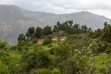 Fototapeta na wymiar Peasant house on top of a hill surrounded by mountains with vegetation. Boyacá. Colombia.