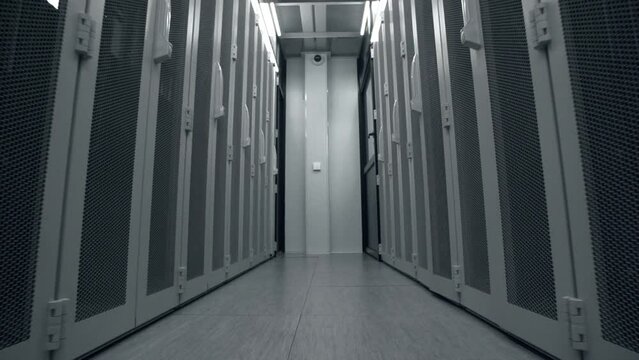 Shot of Corridor in Working Data Center Full of Rack Servers and Supercomputers.