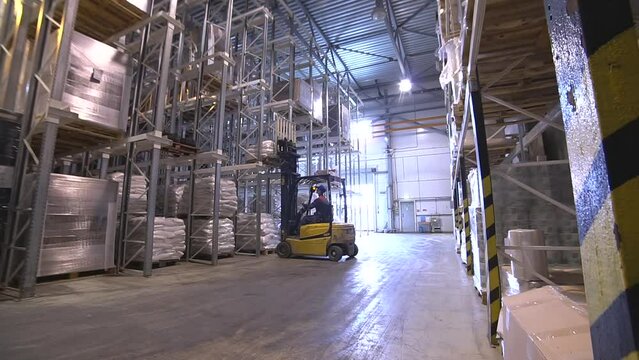 Hand pallet truck, or pallet jack with cargo pallet shipment in blur warehouse. Forklift loader