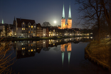 evening view of the center of Lübeck with reflection on the water surface