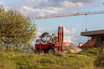 Obraz premium Red forklift truck on a construction site