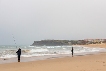 Persistent Fishermen Braving the Stormy Weather on a Portuguese Beach