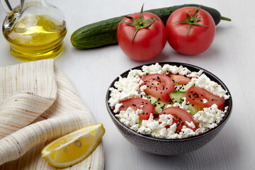 Salad of cucumbers, tomatoes with curd cheese and black cumin seeds