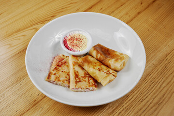 pancakes with cheese and ham, served with sauce