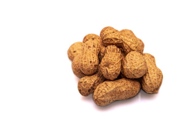 Pile of peanuts on white isolated background in close-up