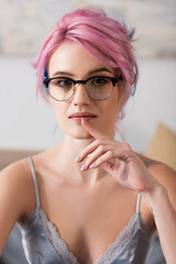 portrait of pretty young woman with dyed hair looking at camera.