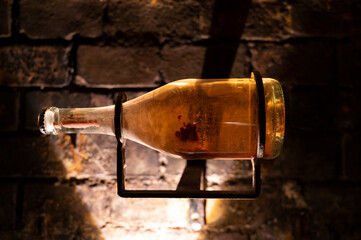 Sparkling wine production by traditional methods in underground cellars in Vienna, Austria. Sediment in bottle.