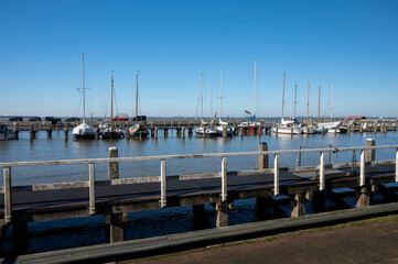 Walking on sunny day in small Dutch town Marken with wooden houses located on former island in North Holland, Netherlands