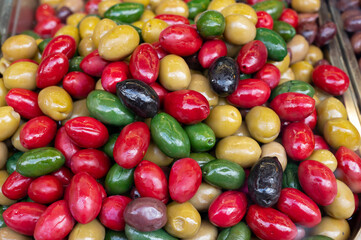 Colorful olives close up on market, food background