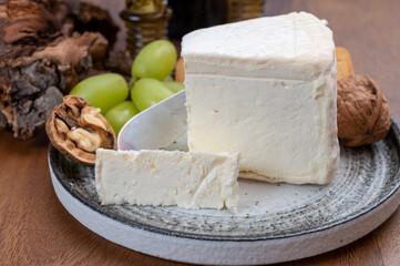 Delice de Bourgogne French cow's milk cheese from Burgundy region of France served with grapes, wine and walnuts