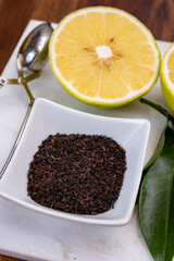 Making tasty aromatic earl-gray tea with fresh ripe bergamot citrus fruit