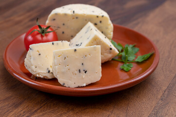 Traditional polish white cheese with black chives seeds made in North Poland in Kaszebe area near Gdynia.