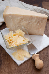 Flakes of parmesan cheese, italian hard parmigiano-reggiano cheese from Reggio Emilia region