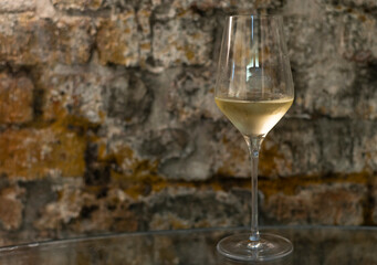 Tasting of brut champagne sparkling wine produced by traditional method in underground caves