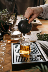 Traditional tea ceremony - pouring chinese oolong in glass cup