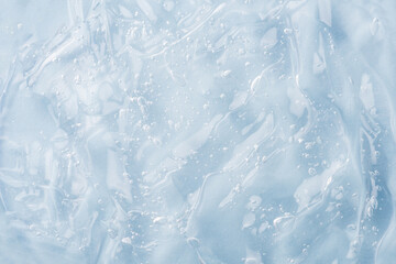 Closeup clear blue, moisturizer, hygiene product, alcohol gel, liquide serum, shower gel, hand sanitizer, colored cream texture product sample with bubbles. Transparent abstract background