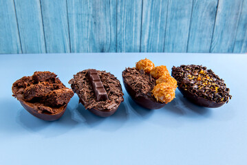 Chocolate filled easter eggs on blue background, easter concept