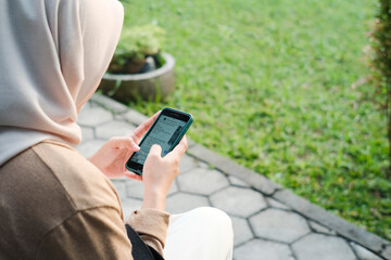 person using mobile phone in park