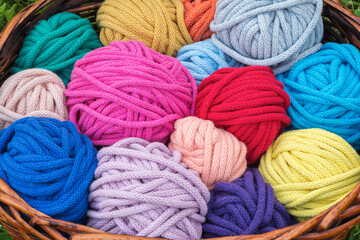 Colorful knitting wool balls in a wicker basket