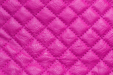 Quilted fabric texture. The repetitive pattern of leather with pink diamond stitching