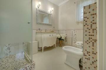 toilet and detail of a corner shower cabin with wall mount shower attachment