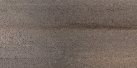 view from above on surface texture of old asphalt road with cracks