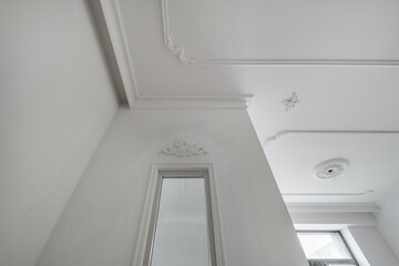 corner of ceiling cornice with intricate crown molding.