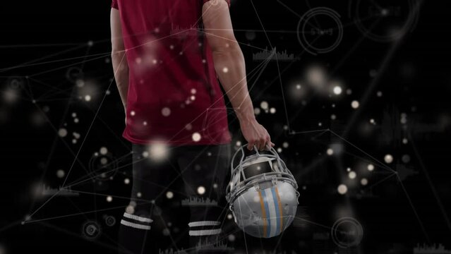 Animation of data processing over caucasian male american football player with ball