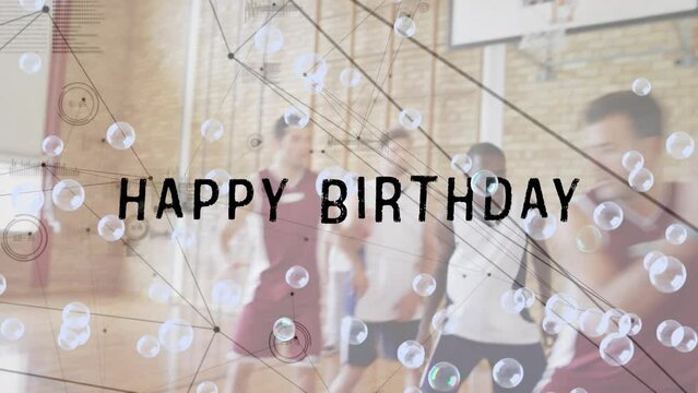 Animation of happy birthday text and bubbles over diverse group of basketball players at gym