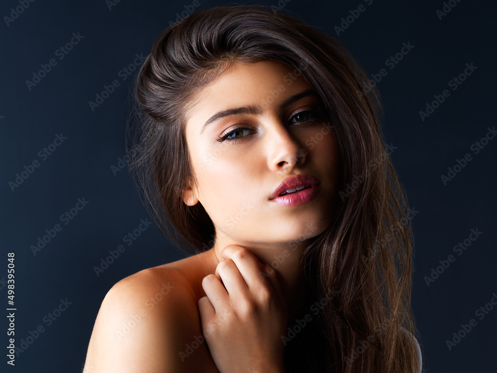 Wall mural Confidence is an attractive trait. Cropped portrait of a gorgeous young woman posing against a dark background.