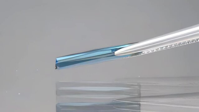 natural blue tourmaline indicolite baguette in the tweezers