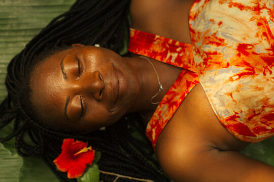 Portrait of a black African environmentalist laying in nature 