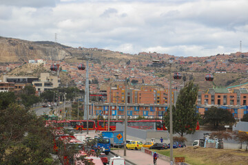 metrocable in the city with highway traffic and apartments