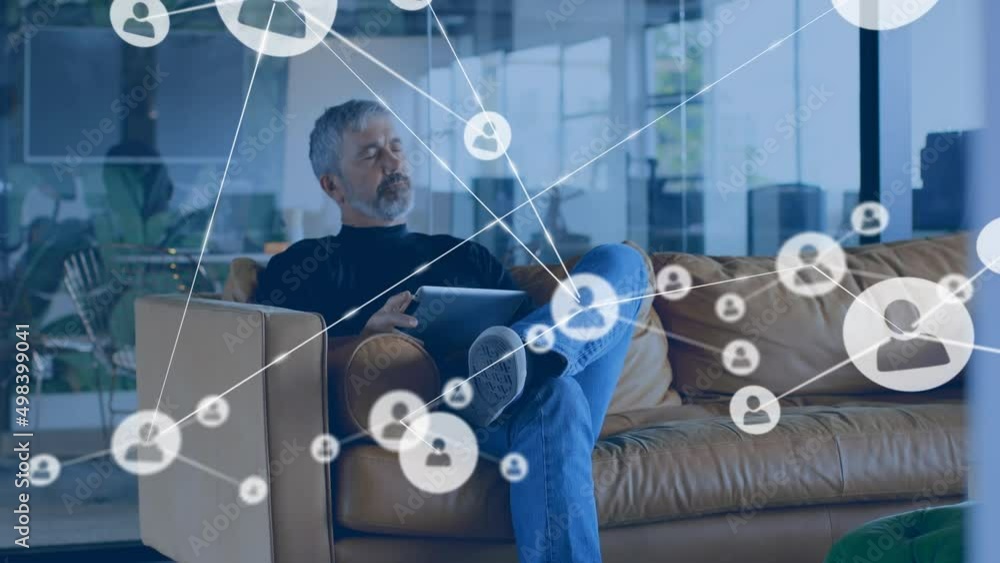 Poster animation of network of connections with icons over caucasian businessman using tablet
