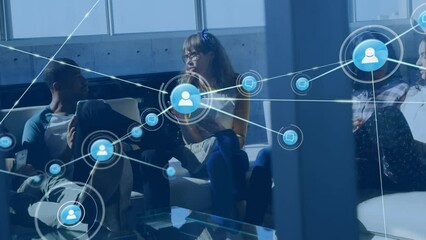 Animation of network of connections with icons over diverse business people using laptop - Powered by Adobe