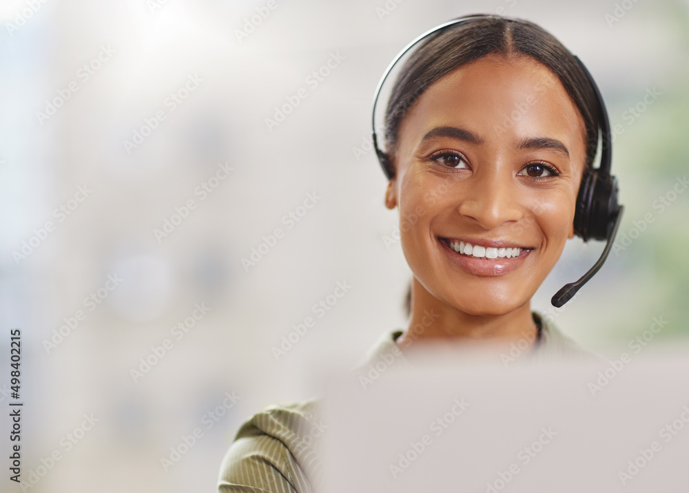 Poster im ready to make your day. shot of a call centre agewnt smiling while sitting at her desk.