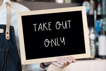 Barista hand holding blank chalkboard with take out only words