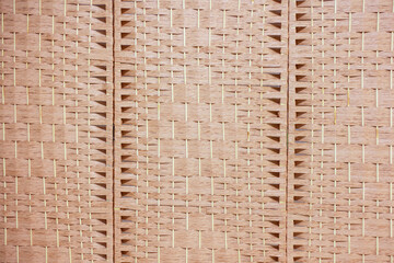 Bamboo wall weave. Traditional handicrafts woven with natural Thai patterns. Rattan flooring for furniture materials. Innovative concept of modern basketry Background image for design.
