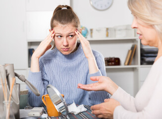 Mature mother and adult daughter scandal in domestic interior. High quality photo