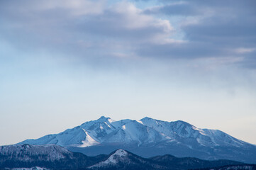 Plakat 朝の遠くの雪山の稜線。日本の北海道の斜里岳。