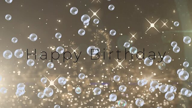 Animation of bubbles and light spots over happy birthday text on beige background