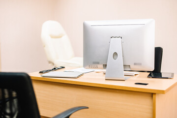 An office desk full of gadgets such as notepads, tablets, keyboards and mouse on wood table.