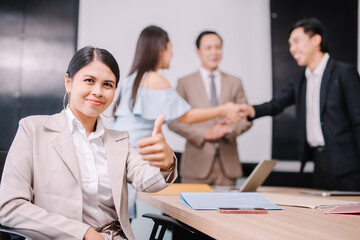 Asian businesswoman giving thumbs up