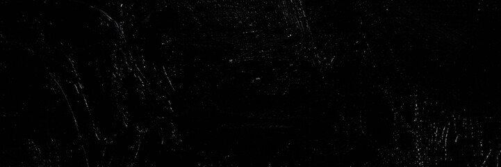 Dark creative background - rough linen canvas unevenly covered with black primer, reflections of light. Toning, blurring, selective focus.