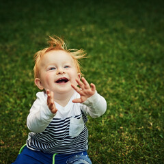 Feeling the joy. Shot of an adorable little boy playing in the backyard.