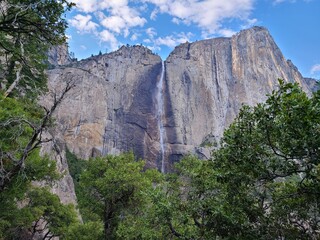 Fototapeta na wymiar Yosemite Falls reduced to a trickle by early summer in Yosemite National Park, California