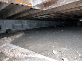 Pipe Running in Dirt Crawl Space Under House - obrazy, fototapety, plakaty